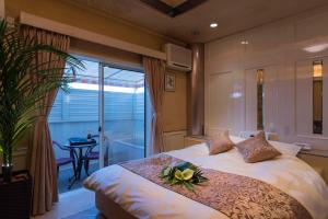 a bedroom with a bed with a flower on it at Hotel Sulata Ashikaga (Adult Only) in Ashikaga