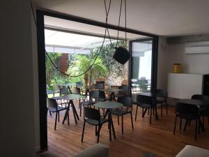 a restaurant with tables and chairs and a large window at Teku Sardinia Boutique Hotel in Bari Sardo
