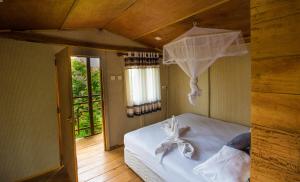a bedroom with a bed with a net at The Thick Forest in Sigiriya +73 photos
