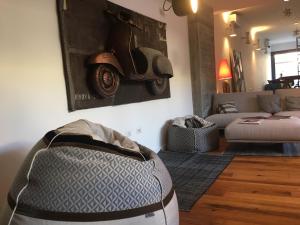 a living room with a couch and a motorcycle on the wall at Teku Sardinia Boutique Hotel in Bari Sardo