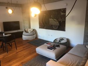 a living room with a couch and a table at Teku Sardinia Boutique Hotel in Bari Sardo
