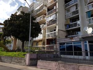 a tall apartment building with a tree in front of it at Apartment Mimi in Herceg-Novi