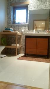 a bathroom with a sink and a mirror at Apartamento do Atlantico in Gala +16 photos