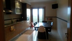 a kitchen with a table and chairs in a room at Apartamento do Atlantico in Gala