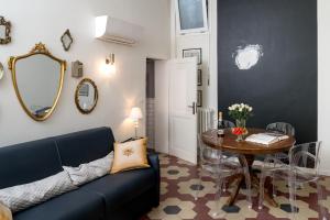 a living room with a blue couch and a table at L'8 Boutique Concept Apartments in Bologna