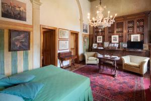 a bedroom with a bed and a living room at Castello di Roncade in Roncade