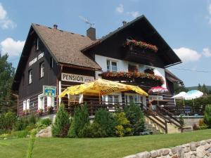 a large building with umbrellas in front of it at Pension Jitka in Harrachov