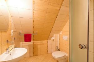 a bathroom with a toilet and a sink at Studia Aurora in Demanovska Dolina +22 photos