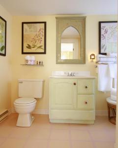 a bathroom with a white toilet and a sink at Beach & King Street Inn in Rockport