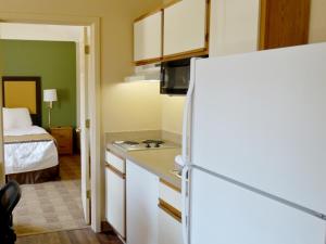 a white refrigerator freezer sitting in a kitchen at Extended Stay America Suites - Philadelphia - Malvern - Swedesford Rd in Malvern