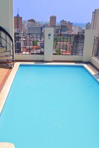 a large swimming pool on the balcony of a building at Hotel Manduara in Asunción