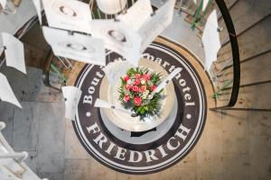 an overhead view of a clock with a bouquet of flowers at Friedrich Boutique-Apartments in Freiburg im Breisgau