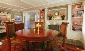a dining room with a wooden table and chairs at Beach & King Street Inn in Rockport +16 photos