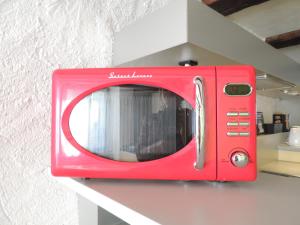 a red microwave sitting on top of a counter at Solothurn in Solothurn