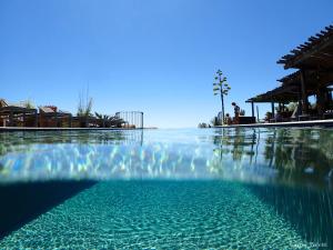 a swimming pool with a blue sky at Les Bergeries De Palombaggia in Porto-Vecchio
