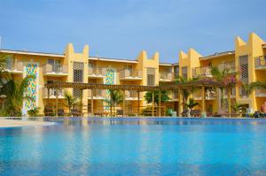 a swimming pool in front of a resort at Apartment | in Tropical Resort | pool | close to beach in Santa Maria