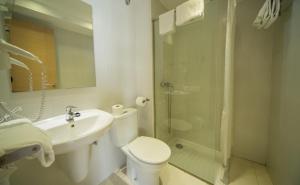 a bathroom with a toilet and a sink and a shower at Apartamentos Embat in Can Pastilla