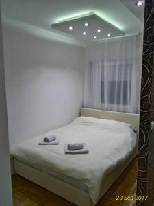 a bedroom with a bed with two towels on it at Apartment Frida in Belgrade