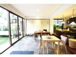 a kitchen and dining room with a table and chairs at House 23 Guesthouse in Bangkok
