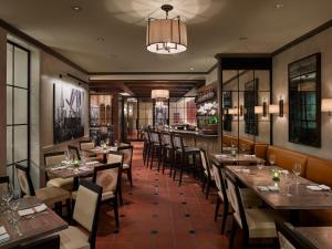 a restaurant with tables and chairs and a bar at Penn's View Hotel Philadelphia in Philadelphia