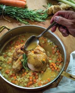 a pot of chicken and vegetable soup with a spoon at Penn's View Hotel Philadelphia in Philadelphia