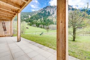 an open porch with a view of a field and mountains at Appartement Ski In by A-Appartments in Brand