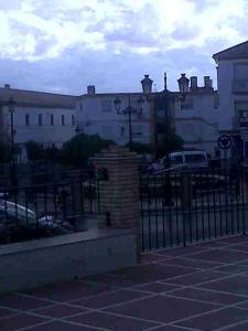 a black fence in front of some buildings at Hostal Medina in Olvera