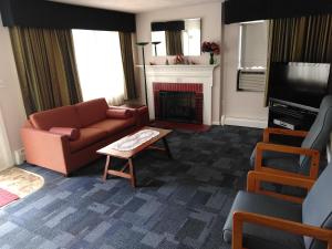 a living room with a couch and a fireplace at The Cardinal Inn in Luray