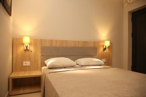 a bedroom with a bed with two pillows on it at Gold Crown Apartments in Jagodina