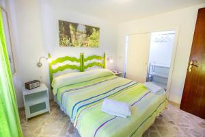 a bedroom with a large bed and a window at Casa Bianca Rais Gerbi in Finale