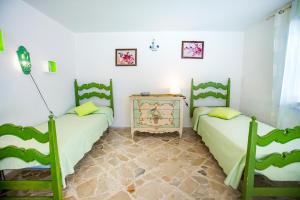 a room with two beds and a table at Casa Bianca Rais Gerbi in Finale