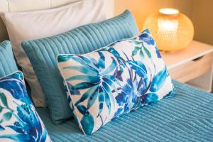 a blue and white pillow on a blue couch at Beach House Ericeira in Ericeira