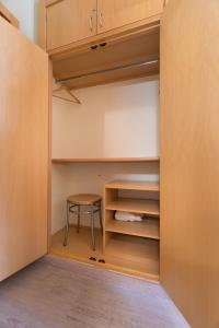 a closet with a stool and a table in it at Beach House Ericeira in Ericeira
