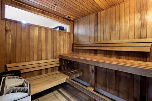 an empty sauna with wooden walls and a window at ULTIQA Shearwater Resort in Caloundra