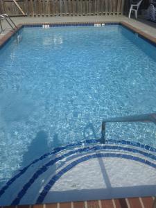 a large swimming pool with blue water at Baymont by Wyndham Cartersville in Cartersville