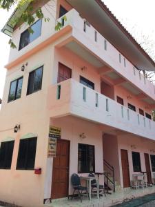 a building with tables and chairs in front of it at Miss Tim House in Ko Samed