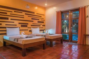 Posteľ alebo postele v izbe v ubytovaní Acacia Tree Garden Hotel