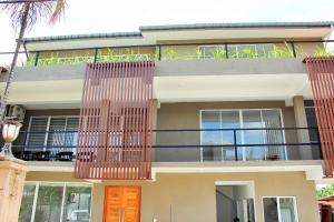 a house with orange doors and a balcony at The Big House in Colombo
