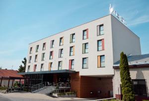 a building with a cross on top of it at IMPIQ Hotel in Trnava