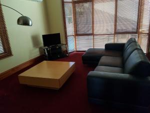 a living room with a couch and a coffee table at King Street Apartments in Warrnambool