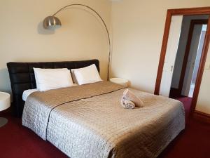 a bedroom with a bed with a pillow on it at King Street Apartments in Warrnambool
