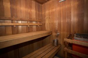 a sauna with wooden walls and shelves in a room at La Maison Boutique Hotel in Katoomba