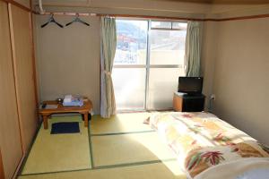 Vuode tai vuoteita majoituspaikassa Weekly Hotel Kokura