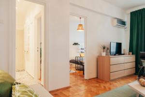 a living room with a door open to a living room at Old Town View Apartment in Bucharest