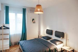 a bedroom with a bed and a chandelier at Old Town View Apartment in Bucharest