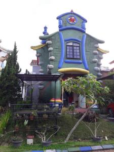 a house shaped like a house with a clock on it at Villa Kota Bunga NA2 in Puncak