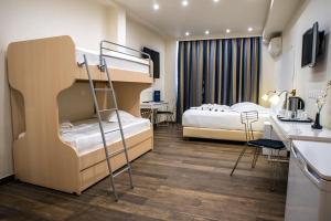 
a bedroom with a bed and a desk at Piraeus City Hotel in Piraeus
