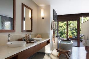 a bathroom with two sinks and a bath tub at Anantara Peace Haven Tangalle Resort in Tangalle