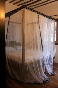 a bed with mosquito netting in a room at Villa Marisella in Kiwengwa