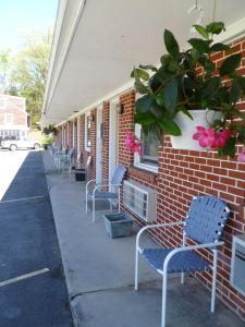 a row of benches sitting outside of a brick building at Lost River Motel in Lost City